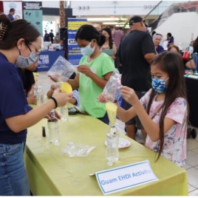 Guam CEDDERS Social Work Intern, Amarah Santos, demonstrating the Sensory Bottle activity during the 1st Guam Early Hearing Detection and Intervention (EHDI) Early Childhood Care & Education Fair held on Saturday, September 24, 2022, at the Micronesia Mall.